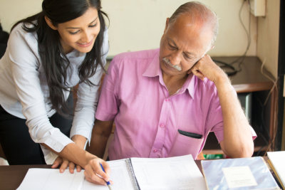 woman helping an elderly with documents